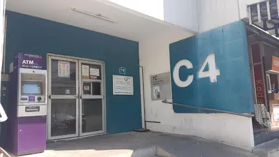 a gas station with a sign on the side of a building at ป๊อปปูล่า คอนโด อาคาร C4 impact เมืองทองธานี in Nonthaburi