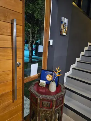 a table with a laptop on it next to a staircase at The Lantern Suites in Ban Song Hong