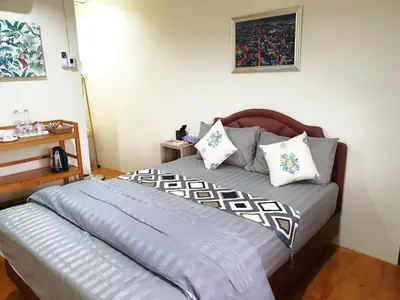 a bedroom with a bed with pillows on it at 297 Nature Residence in Bangkok