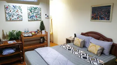 a bedroom with a bed and a desk and a bed sidx sidx sidx at 297 Nature Residence in Bangkok