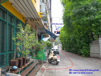 a group of motorcycles parked on the side of a street at Chan Cha La 99 Hostel in Bangkok