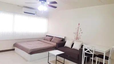 a living room with a couch and a table at Popular Condo C9 in Pak Kret
