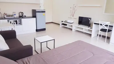 a living room with a couch and a tv at Popular Condo C9 in Pak Kret