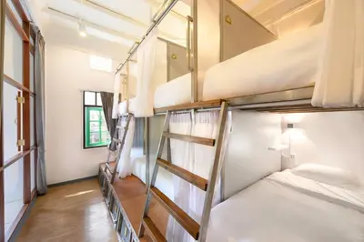 a group of bunk beds in a room at REST IS MORE hostel in Bangkok