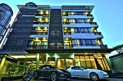 two cars parked in front of a building at The Present Sathorn in Bangkok