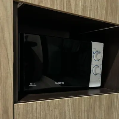 a microwave oven sitting on top of a cabinet at The Gallery condominium in Samut Prakan
