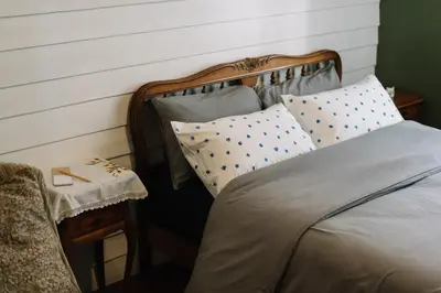 a bedroom with a bed and a side table at Lhong Yaowarat hostel in Bangkok