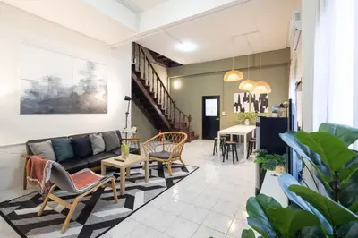 a living room with a couch and chairs and a table at Bai Bua House Chatuchak in Ban Zong Katiam