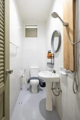a bathroom with a toilet and a sink and a mirror at Bai Bua House Chatuchak in Ban Zong Katiam