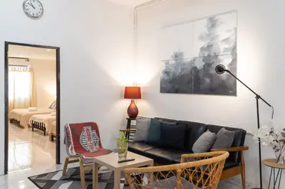 a living room with a couch and a table at Bai Bua House Chatuchak in Ban Zong Katiam
