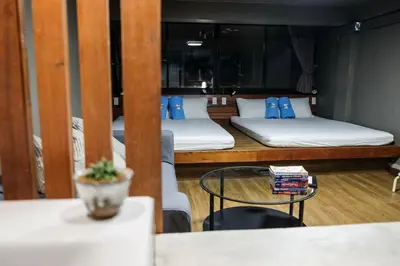 a room with two bunk beds and a table at In a Box Hostel in Bangkok
