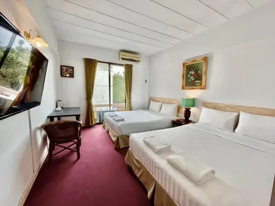 a hotel room with two beds and a flat screen tv at MANGO Lagoon Place in Bangkok