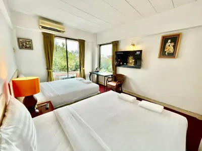 a hotel room with two beds and a window at MANGO Lagoon Place in Bangkok