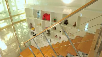 a staircase with white shelves with figurines on them at Duplex 21 Apartment in Bangkok