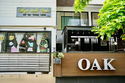 a restaurant with a oak sign on the side of a building at Pentafield City Residence in Amphoe Phra Khanong