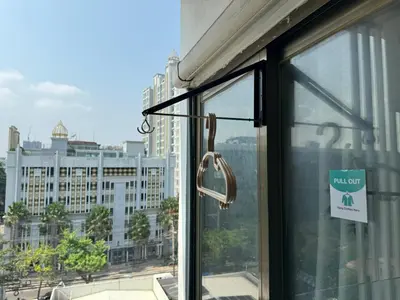 a window with a view of a city at Pentafield City Residence in Amphoe Phra Khanong