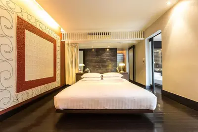 a bedroom with a large white bed in it at Loogchoob Homestay in Bangkok