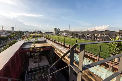a balcony with a view of a field at Loogchoob Homestay in Bangkok