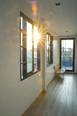 a room with a bench and two windows at YAKTHAI POSHTEL in Bangkok