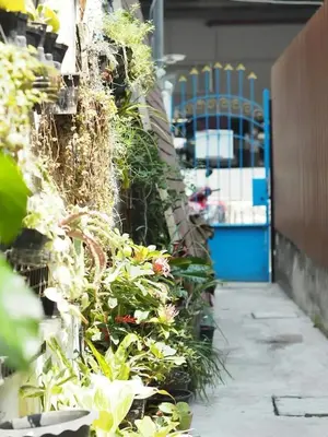 a building with plants on the side of it at Makkasan Happy Home in Bangkok