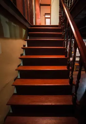 a staircase in a building with wooden railings and wooden steps at Yesterday Sathon in Bangkok