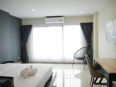 a bedroom with a bed with two teddy bears on it at Thanks​Pama​ in Bang Khen