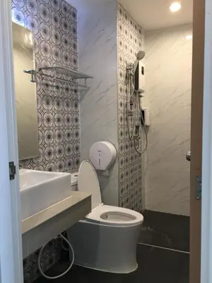 a bathroom with a white toilet and a sink at Thanks​Pama​ in Bang Khen