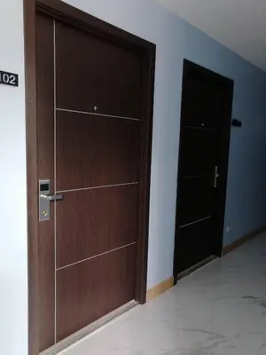 a room with a wooden door and a closet at Thanks​Pama​ in Bang Khen
