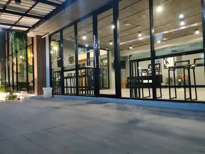 a store front with glass windows and a patio at Thanks​Pama​ in Bang Khen