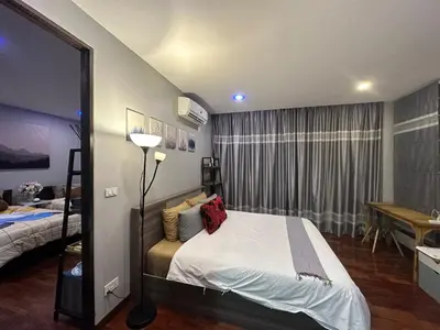 a hotel room with a bed and a window at PomPom Home in Bangkok