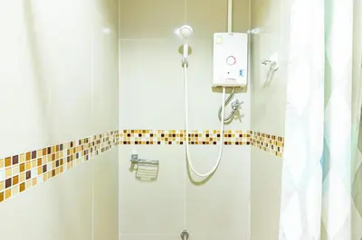 a shower in a bathroom with a shower curtain at Ascella Sukhumvit 38 - Thonglor in Bangkok