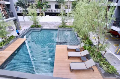 an overhead view of a swimming pool with two lounge chairs and sidx sidx at Comfy Condo On Nut in Bangkok