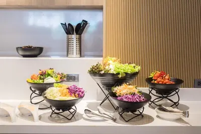 a group of bowls of vegetables on a table at Madison Bangkok Hotel in Bangkok