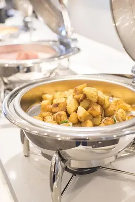 a pot of food in a pan on a stove at Madison Bangkok Hotel in Bangkok
