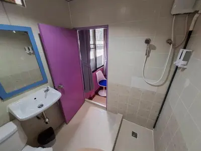 a bathroom with a purple shower and a sink at Wow Guesthouse in Bangkok