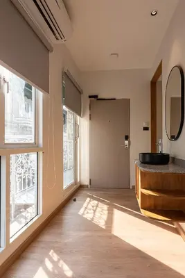 a bathroom with a sink and a large window at Boxpackers Pratunam in Bangkok