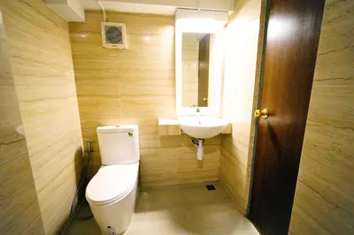 a bathroom with a toilet and a sink at Wild Orchid Villa Bangkok in Bangkok