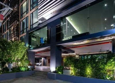 an exterior view of a building with plants at Amarin Hotel Rama 8 in Bangkok