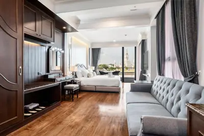 a living room with a couch and a bed at ARUN Riverside Bangkok in Bangkok