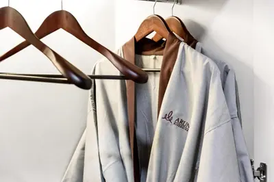 a group of shirts hanging on a rack at ARUN Riverside Bangkok in Bangkok