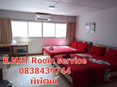 a bedroom with a red bed and a red room service sign at K.NAT Room service in Nonthaburi