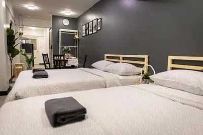a bedroom with two beds with towels on them at T1 Large Studio Full kitchen 100m. to BTS in Bangkok