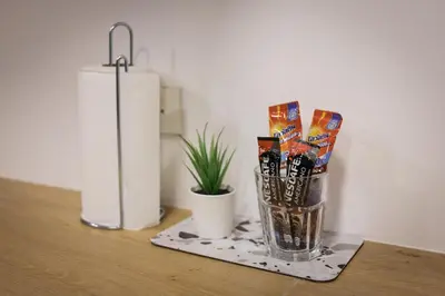 a vase of candy on a table next to a candle at T2 2 Bedrooms 6 guests Full kitchen 1 min to BTS in Bangkok