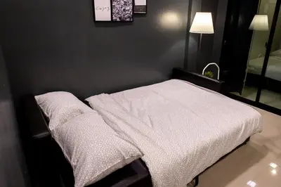 a bedroom with a bed with a white blanket at T5 2 Bedrooms/6guests/full kitchen/1 min to BTS in Bangkok