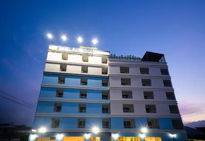 a white building with lights on top of it at The Willing Hotel and Residence in Lak Si