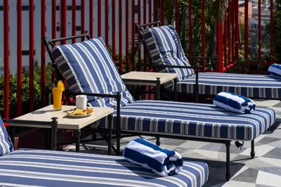 a group of blue and white chairs sitting on a patio at MeStyle Museum Hotel in Bangkok