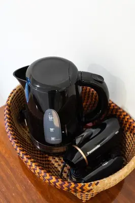 a black coffee mug in a basket on a table at Baan Boon in Bangkok