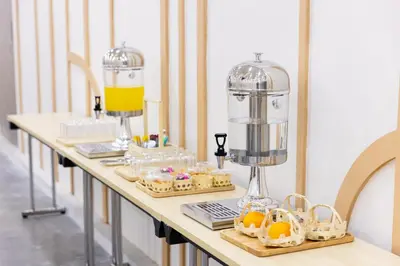 a table with cookies and a food processor on it at Nappiness Hotel in Bangkok