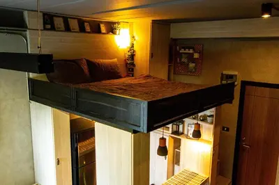 a bed is hanging from the ceiling of a room at 44 Room Rama 3 in Bangkok