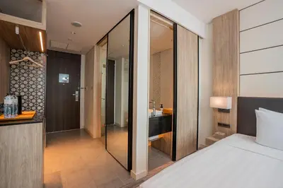 a bedroom with a bed and a bathroom at Solaria Nishitetsu Hotel Bangkok in Bangkok